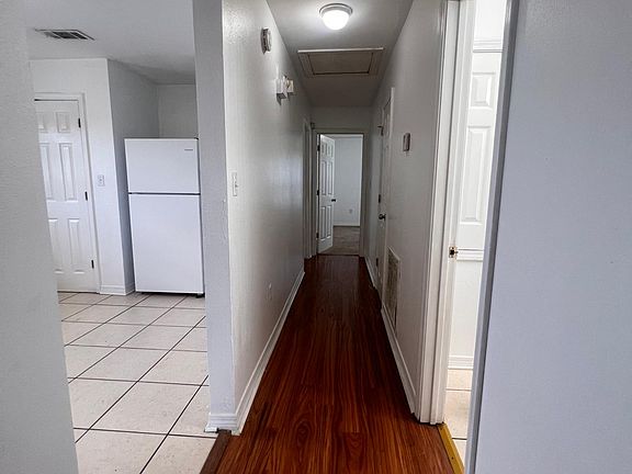 this is the hallway right off the kitchen that leads to all three bedrooms two on the left one on the right