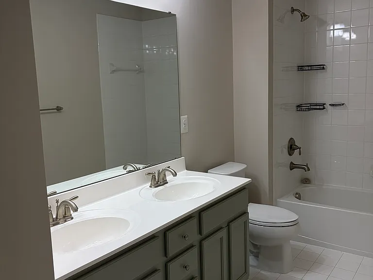 Double vanity sink area with ample storage available in the linen closet.