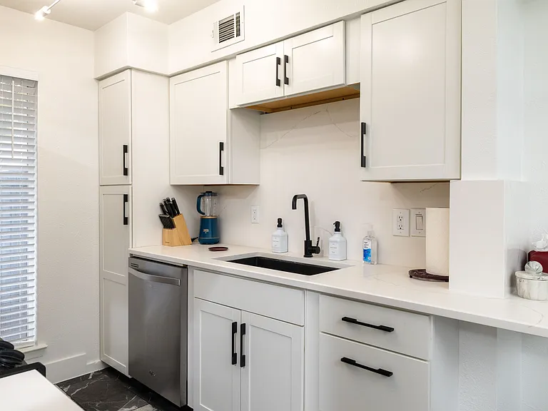 Cook with ease in this modern kitchen featuring stainless steel appliances, sleek countertops, and stylish cabinetry. Fully equipped for meals and late-night snacks.