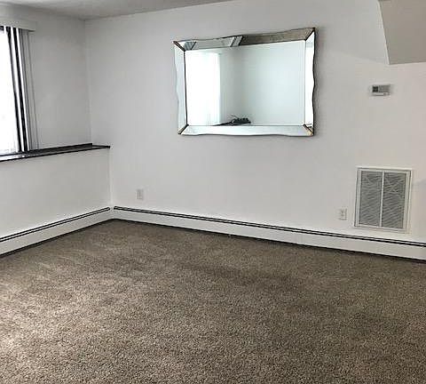 Livingroom with large mirror. Can be moved or removed at tenant's request.