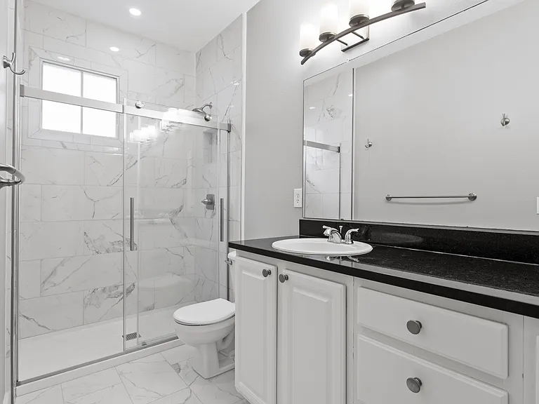 Master bathroom with double vanity and walk-in shower