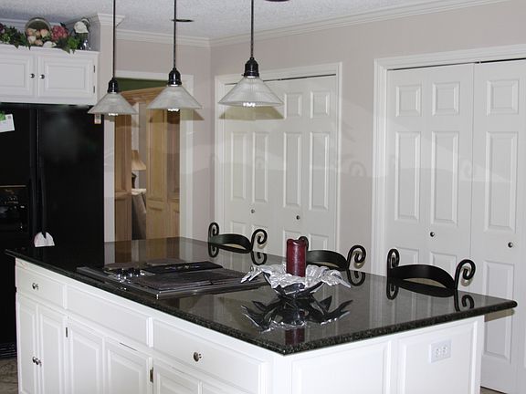 Large granite island with eating area.