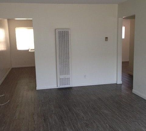 Wood laminate flooring throughout.