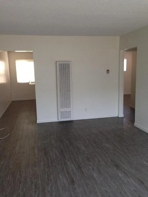 Wood laminate flooring throughout.
