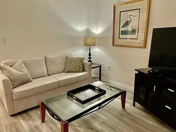 Comfortable couch, end table, coffee table, lamp,TV console and TV