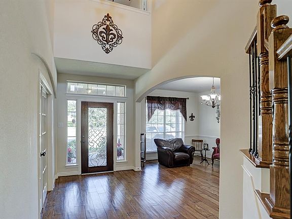 Inviting two story entry with beveled glass mahogany front door.