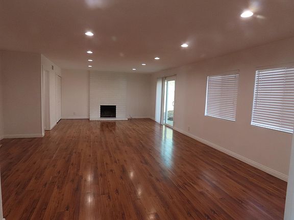 After walking into the home, you enter the combined dining room and living room area. This view is from the dining room to the living room.