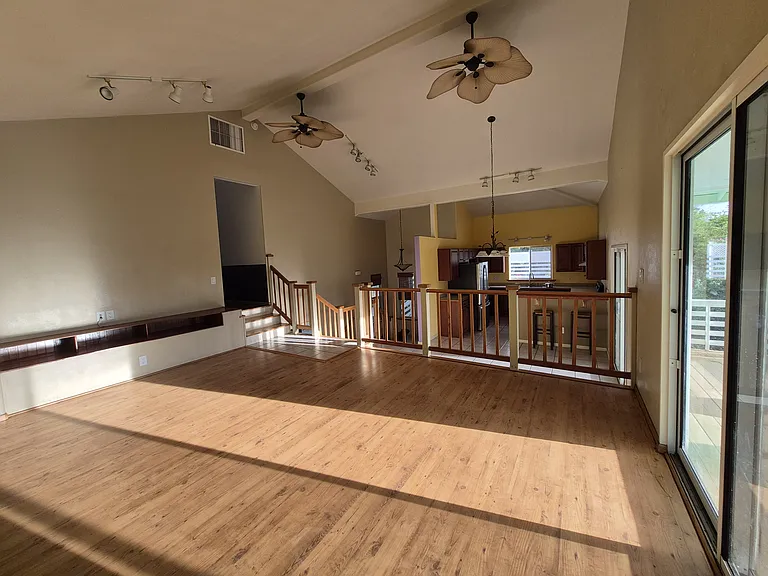 Open-concept living / dining room space with high ceilings