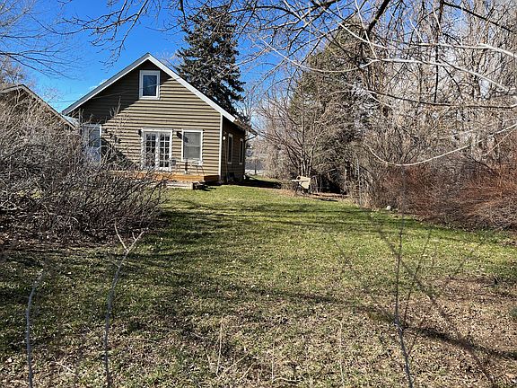 View of yard and cottage from street