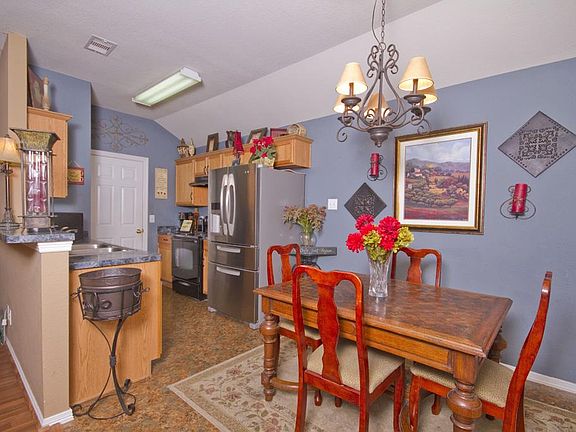Great kitchen perfect for conversing with family and friends while preparing your meals! Great paint - neutral but not boring. Dining area perfectly located with nice light fixture.