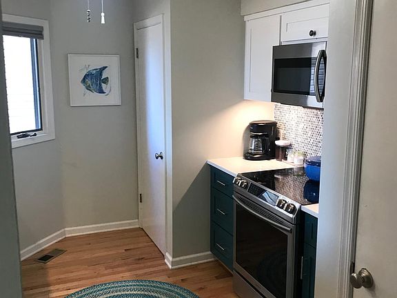 Upgraded appliances with stackable washer/dryer in closet left of stove and large pantry to right