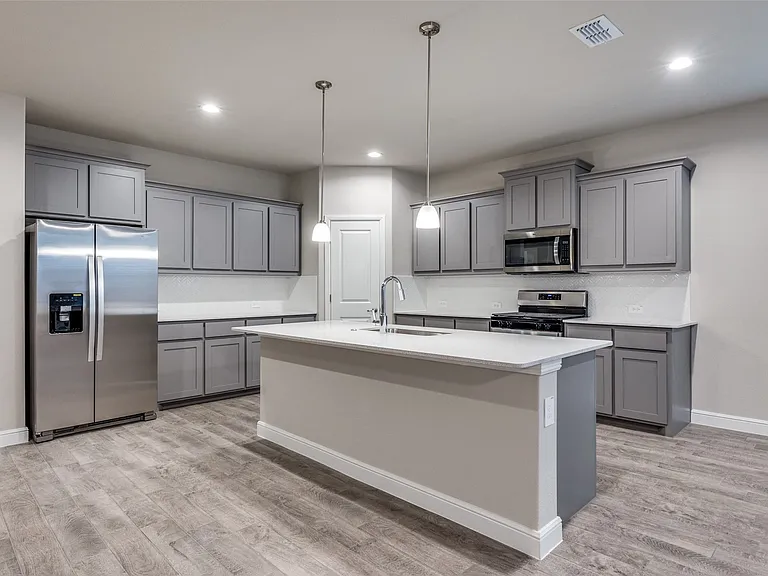 Kitchen featuring gray cabinetry, sink, appliances with stainless steel finishes, and light hardwood / wood-style floors