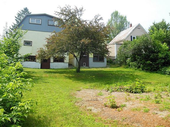 The back yard and a view of the rear of the home.