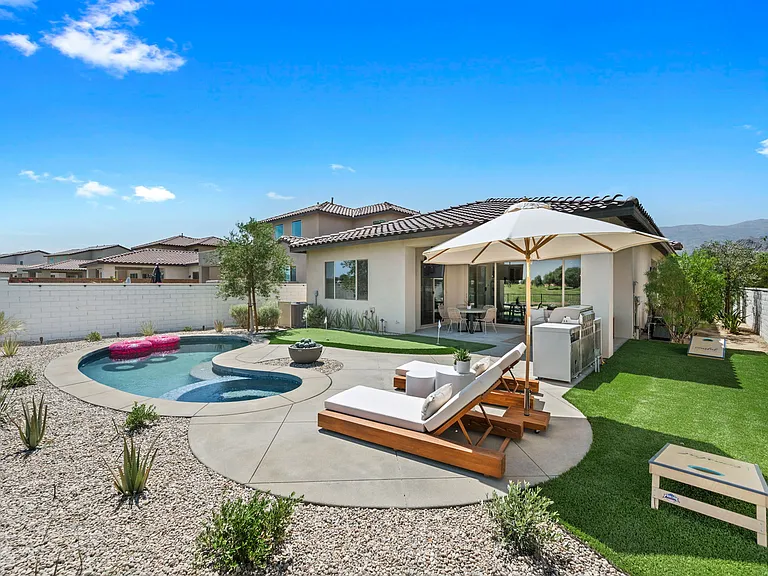 Enjoy shade from the patio umbrella.