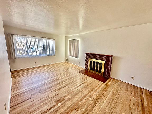 Sunny living room with refinished hardwood floors.