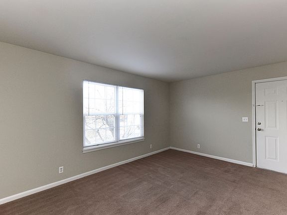 Spacious living room with carpet