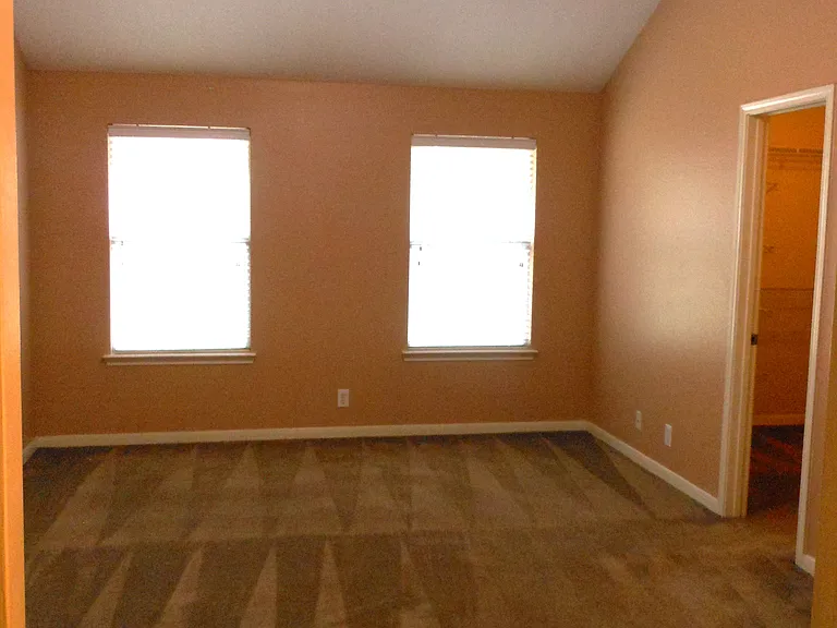 Primary bedroom downstairs with spacious walk-in closet on left.