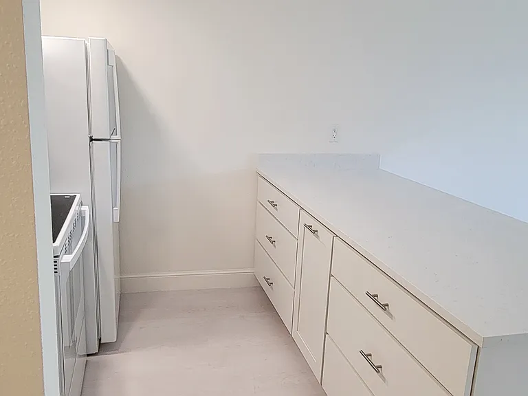 Soft-close, high-end cabinetry with quartz countertops.