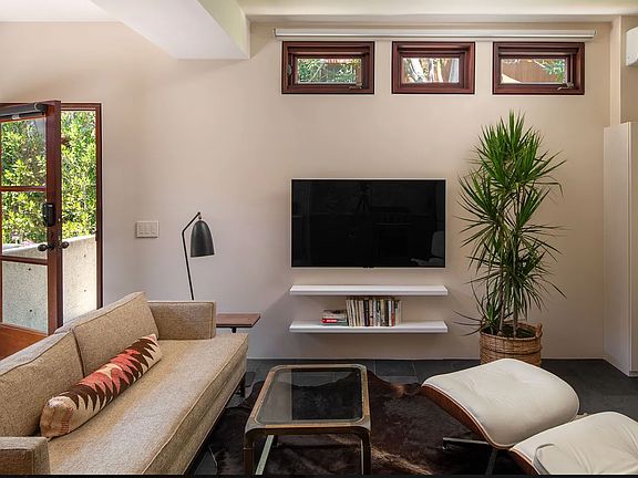 Stylish living room with new LG ULED TV. Remote operated black out shades.