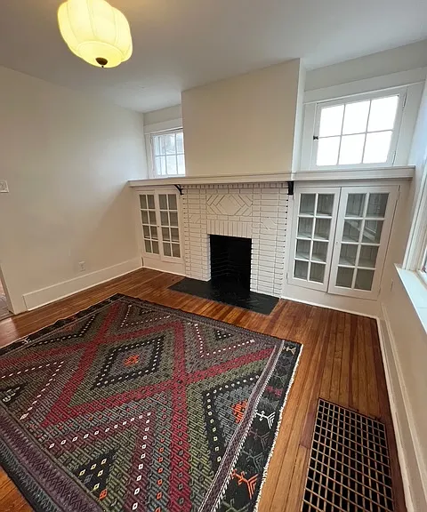 Spacious dining room including brand new lighting fixtures, updated paint, and refinished hardwood floors.