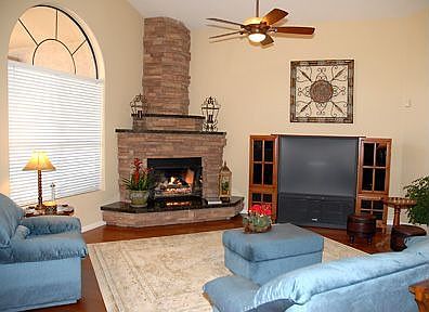 Stacked stone fireplace is a warm highlight in this lovely open floor plan.