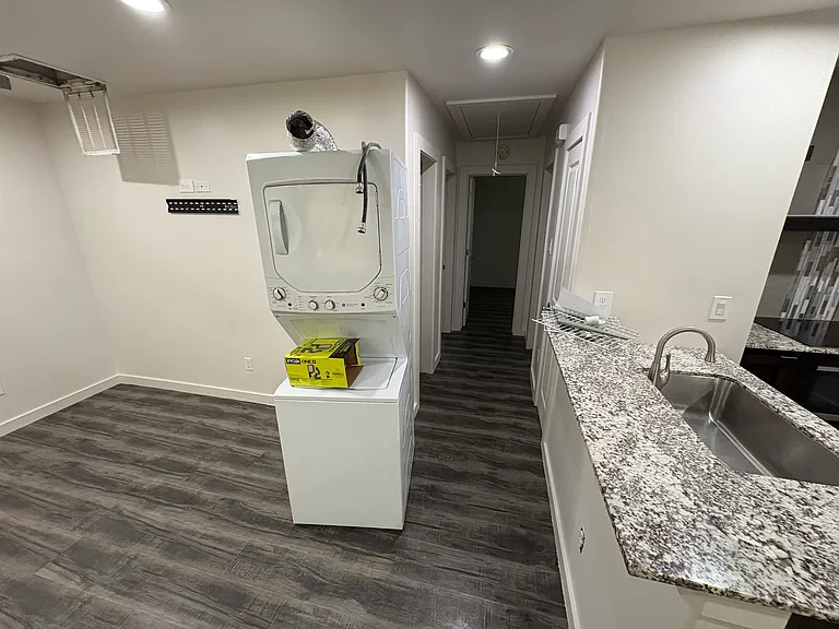 living room area to the hallway with kitchen on the right