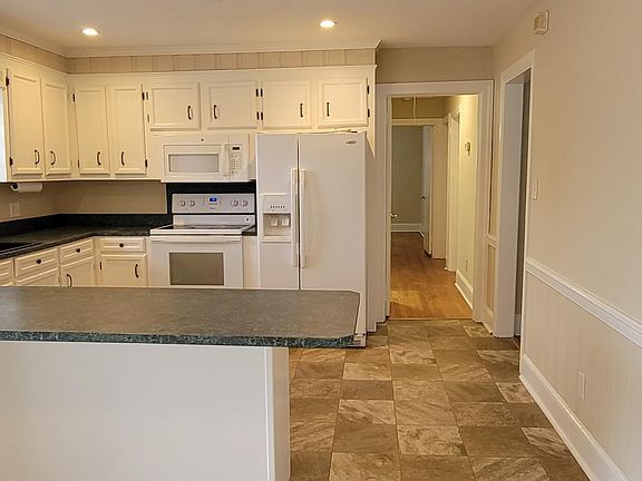 Kitchen with refrigerator, built-in microwave and dishwasher.