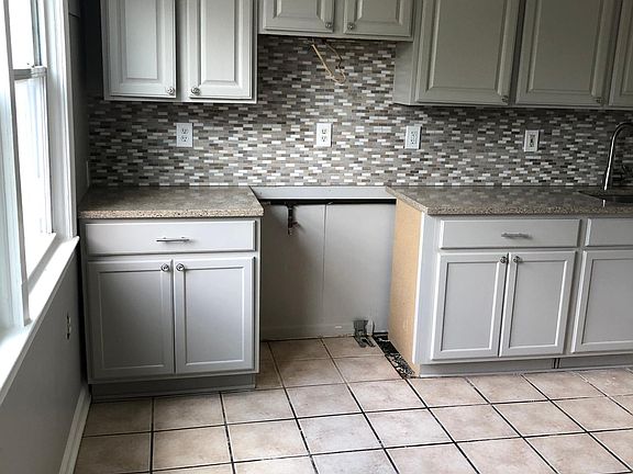 Cabinets, countertops and place for stainless-steel self-cleaning range.