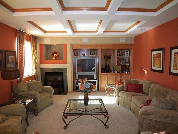Large familyroom off the kitchen with built ins and box beam ceiling