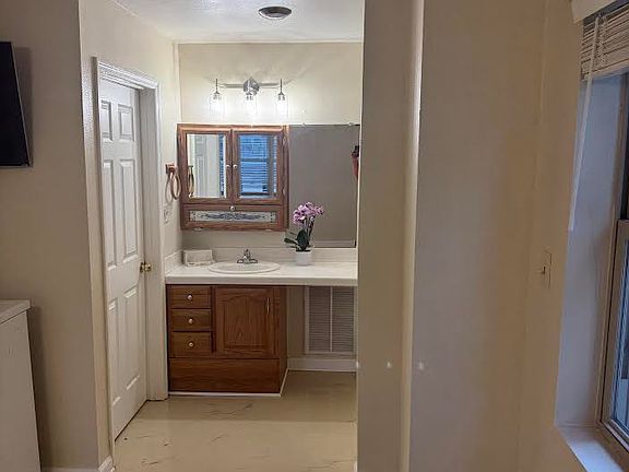 Bath is unique, Epoxy flooring, vanity is seperated from tub and toilet.