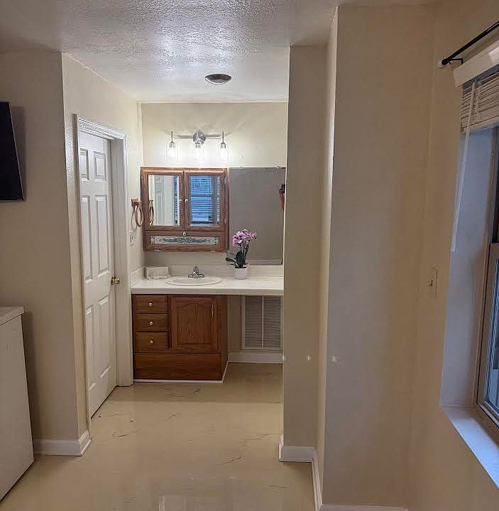 Bath is unique, Epoxy flooring, vanity is seperated from tub and toilet.
