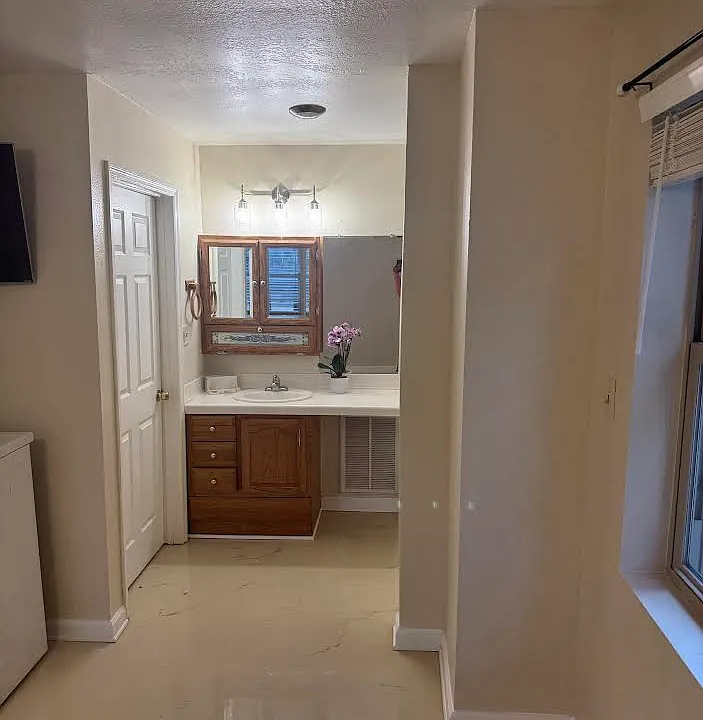 Bath is unique, Epoxy flooring, vanity is seperated from tub and toilet.
