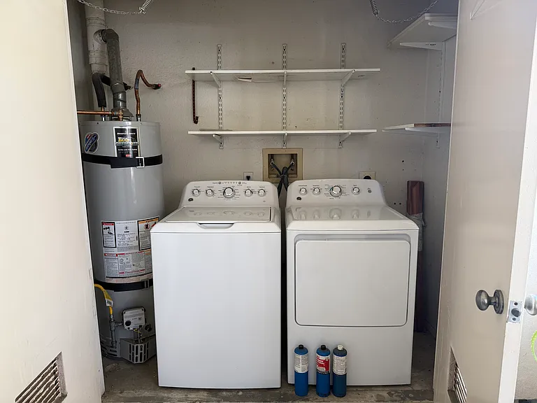 Washer and dryer located inside the patio.