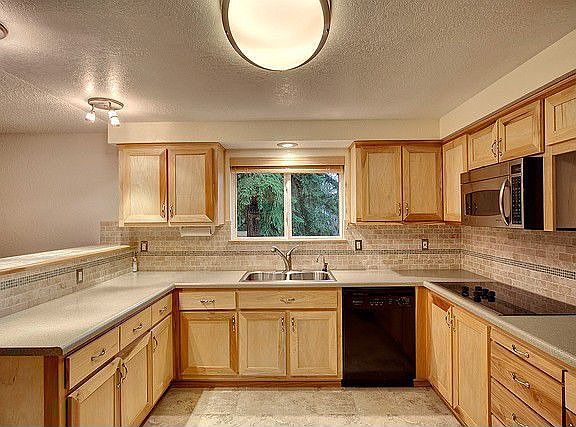 Another view of the kitchen that is functional and beautiful. Views to the park like setting outside