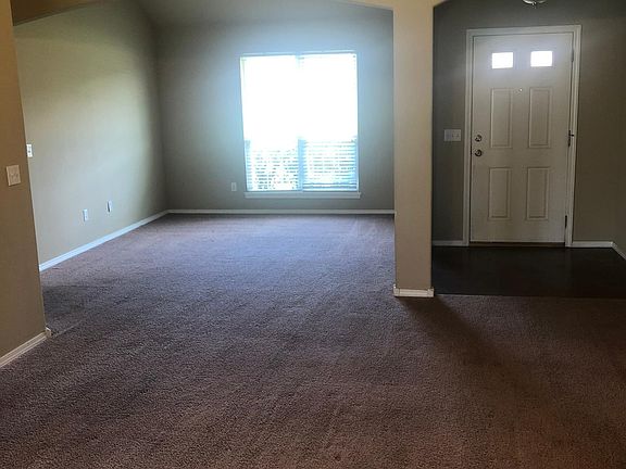 Living room looking to front door & formal dining/office