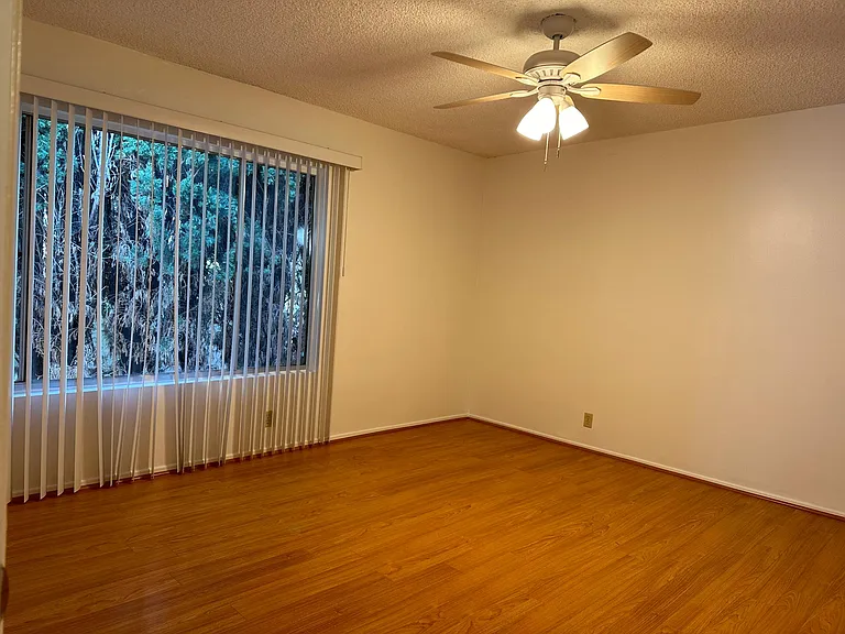 Large Bedroom with ceiling fan and large window