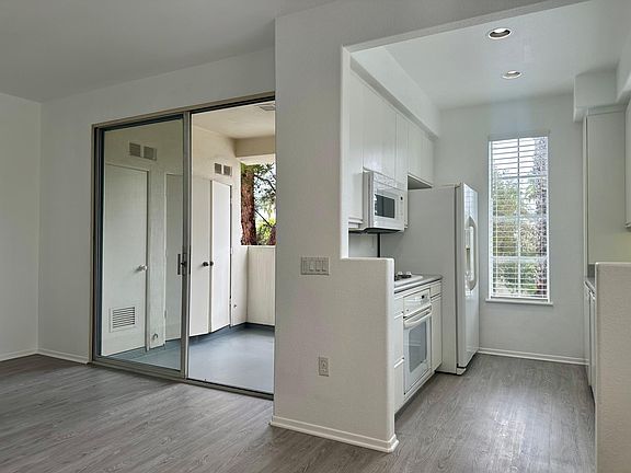 Living room has sliding doors that open to covered private patio.