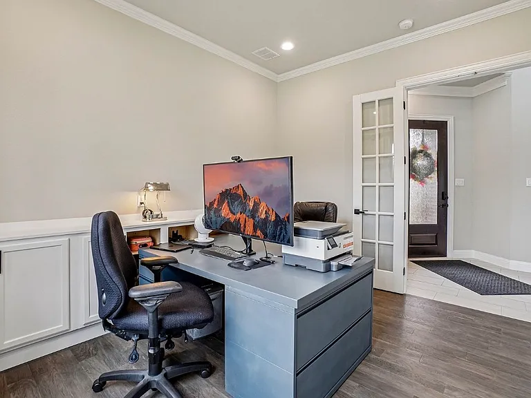 Office with a wall of cabinets and glass French doors