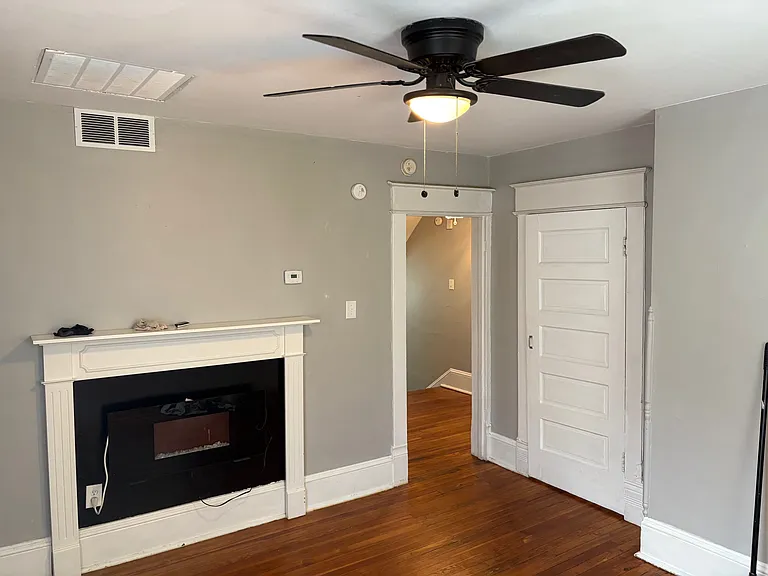 Living Room w/ Refinished Original Hardwood Floors and Designer Lighting. All Blinds provided by landlord. New Sherwin Williams Designer Paint. New Electric Fireplace and Mantle,
