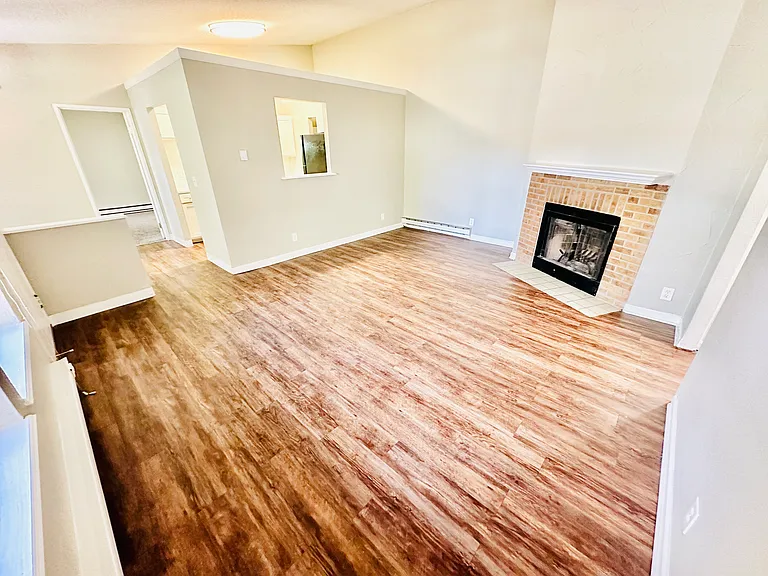 Embrace comfort in this inviting living space with elegant wood floors and a charming fireplace. Embrace comfort in this inviting living space with elegant wood floors and a charming fireplace.