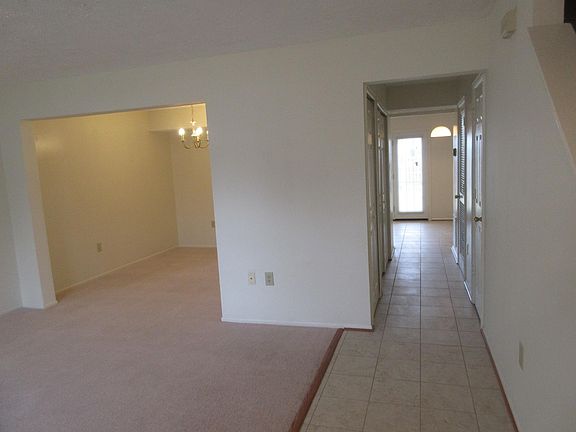 Entry view of living/dining area hallway with washer/dryer, powder room, breakfast nook