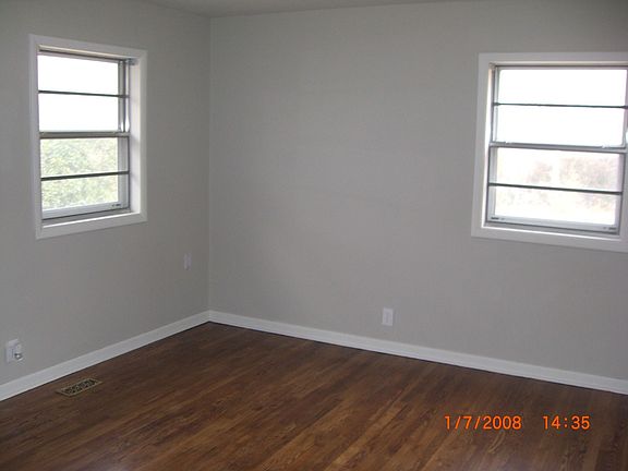 Master bedroom with beautiful hardwoods & updated lighting fixtures.