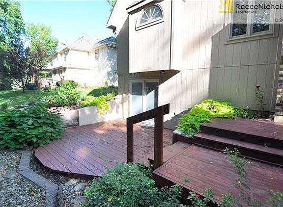 Basement walks out to beautifully landscaped yard and lower deck that is wrapped into a grill deck and main level covered deck