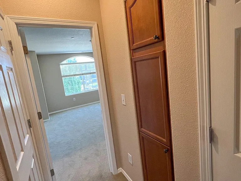 Outside the entry to bedroom2. Linen closet on right and large common closet on left.