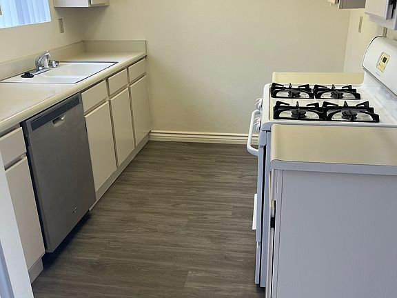 Kitchen with newer dishwasher and gas range