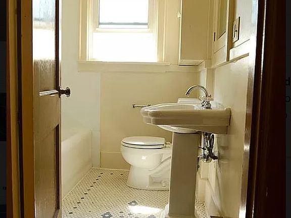 bathroom with tub and shower and built in cabinets