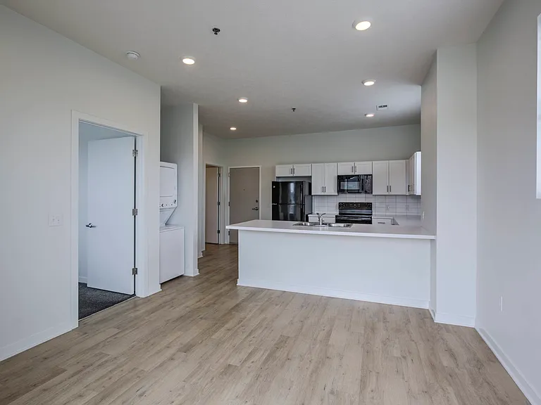 Modern living room and kitchen in a unit at The Rise.