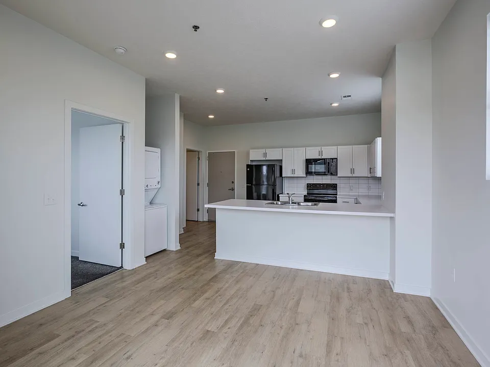Modern living room and kitchen in a unit at The Rise.