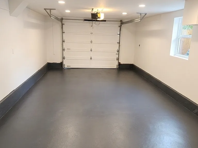 Garage with new automatic garage door and keypad. Resurfaced and painted floors. Freshly painted walls.