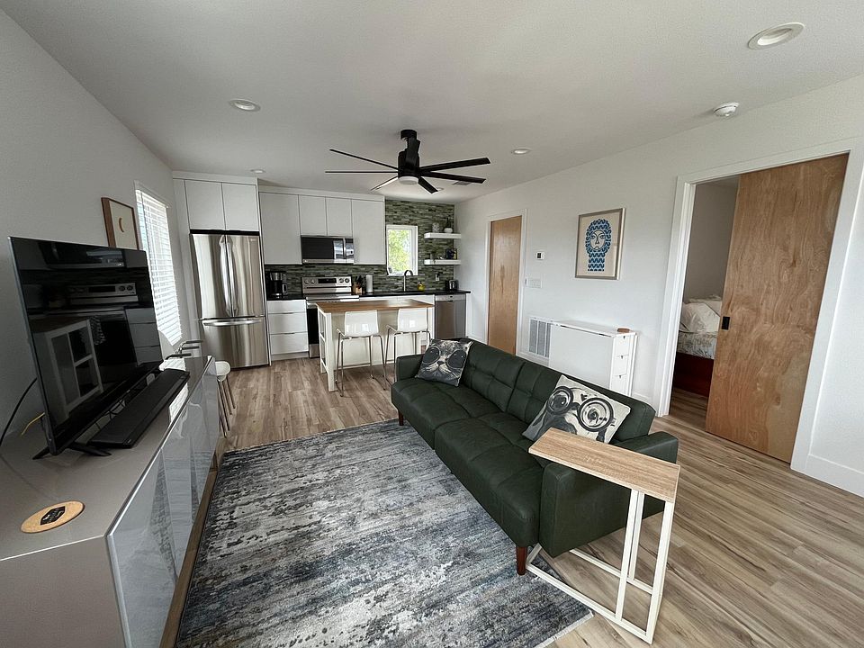 Fabulous and cozy living room with a new Smart TV and fold-out futon couch.
